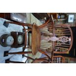 A 19th century yew and elm wheel back Windsor elbow chair,