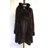A Paula Lishman hand-made in Canada dark brown sheared beaver swing coat with concealed side