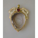 An antique crystal locket with white enamelled garnet set bow,