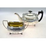 A George III oblong silver teapot and matching sugar basin in the Regency taste,