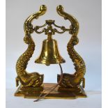 A modern heavy brass small ship's bell on double dolphin brackets,