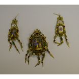 A 19th century gilt metal baroque pendant/brooch set with a Neo-classical ceramic plaque surrounded