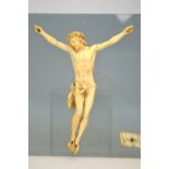 A 19th century ivory crucified Christ, 21 x 17 cm overall, with INRI scroll,