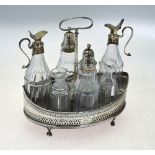 A George III silver cruet stand of eliptical form with engraved and pierced sides, loop handle,
