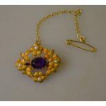 An antique amethyst and pearl flower brooch,