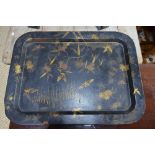 A 19th Century papier mache tray with gilt decoration of insects and flowers on a black ground.
