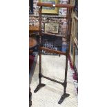 An Edwardian turned and stained walnut clothes airer, on shaped trestle feet,