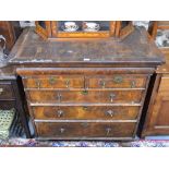 A late 17th/18th century mixed fruitwood chest with rounded cavetto drawer over two short and three