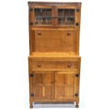 Wilf 'Squirrel Man' Hutchinson, a golden oak cabinet in two parts,