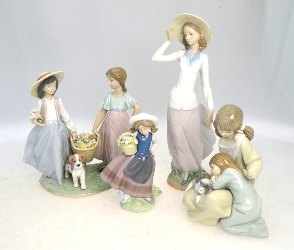 Four Lladro figures, comprising: one of a standing girl in a hat,