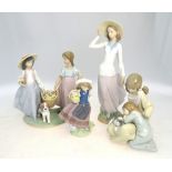 Four Lladro figures, comprising: one of a standing girl in a hat,