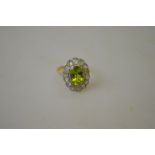 An oval peridot and diamond cluster ring,