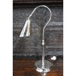 An electroplated adjustable desk lamp with conical shade,