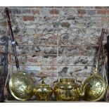 A late 17th century brass warming pan with relief decoration to the hinged cover,