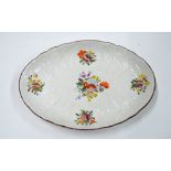 An oval dish, decorated with floral sprays and a moulded design,