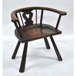 A primitive oak chair, the single piece seat with pierced heart shaped splat and hoop back,