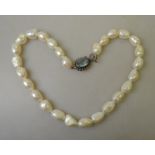 A single row of large baroque cultured pearls on white metal snap stamped 925,