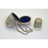 A late Victorian foliate-chased silver ovoid thimble-holder with suspension chain and hinged top