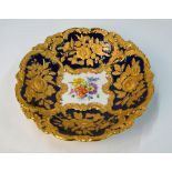 A Meissen circular fluted dish, cobalt blue ground with moulded gilt floral and foliate decoration,