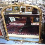 A Victorian giltwood and gesso framed arched overmantel,