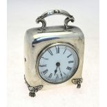 A late Victorian silver desk clock with top scroll handle,
