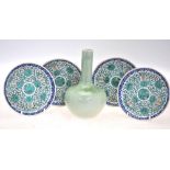 A green monochrome bottle vase; together with four Chinese blue and green enamel saucer dishes;