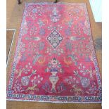 An antique Persian Mashad rug, the floral pole design with birds on red and cream ground,
