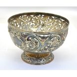 A late Victorian bowl ornately pierced and chased with floral, scroll and bird decoration,