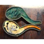 A Meerschaum pipe, finely carved with an egg and eagle's claw,