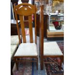 A pair of oak framed high back Arts & Crafts style chairs after a design by Charles Rennie