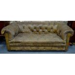 A Victorian/Edwardian buttoned tan/brown leather Chesterfield sofa with brass studded detail,