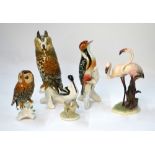 Four Continental porcelain models of birds including two owls, all bearing underglaze blue mark,