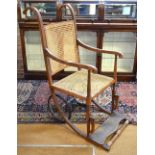A 19th Century birch invalid's chair with caned seat and back,