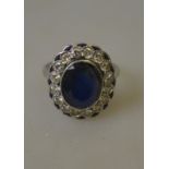 An Art Deco ring having oval sapphire in centre with diamonds around,