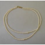 A double row of graduated cultured pearls on 9ct clasp set with four small pearls