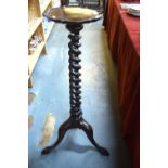 A Georgian style mahogany spiral column jardiniere stand raised on a tripod base with claw and ball