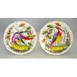 A pair of 19th century pottery shaped plates painted with fancy birds,