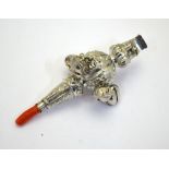 A Victorian infant's embossed silver rattle with whistle, five bells and coral teether,