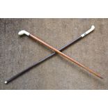 Two early 20th century ivory-handled walking canes Condition Report One handle