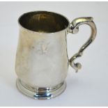 A George III provincial silver small baluster mug with scroll handle and moulded foot-rim,