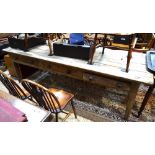 A large Victorian scrub plank top kitchen table, the frieze with three drawers,