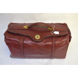 A 'Le Lorrain' red leather travel holdall to/w a pale tan leather suitcase with moire fabric lining,
