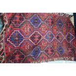 A large Kurdish rug, the field of geometric compartments executed in colours,