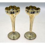 A pair of Art Nouveau silver tulip vases of organic form, on circular weighted bases,