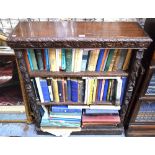 A late 19th century carved oak open bookcase with three adjustable shelves, raised on a plinth base,