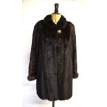 A dark brown mink coat with neat collar and turned cuffs,