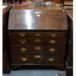 An 18th century oak bureau, the fall enclosing an interior of niches,