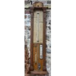 An Admiral Fitzroy oak cased barometer with mercury column,