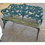 An antique Coalbrookdale fern design garden bench with woodslat seat,