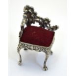 An Edwardian silver novelty pin cushion in the form of a rococo-style corner chair, Birmingham 1901,